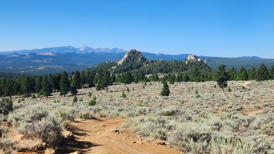 A great view of Spire Rock from Here To There Trail. The Highland Mountains are seen in the background.