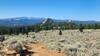 A great view of Spire Rock from Here To There Trail. The Highland Mountains are seen in the background.