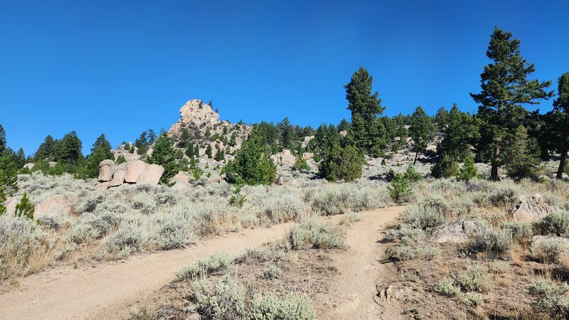 Happy Place Trail climbs up an around the side of this impressive rock outcrop.