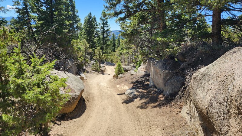 The sandy ATV trail BLM #14 winds through granite boulders.