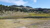 A small water reservoir beside the Norton Gulch Trail is surrounded by beautiful scenery.