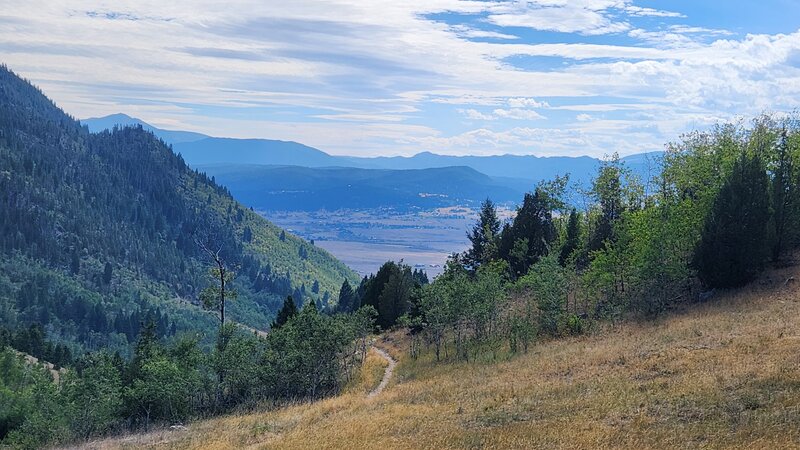 Looking down the descending left of the Maud-S loop trail, with the Highland Mountains in the background.