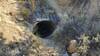 An old mine tunnel beside the Danmor Trail. A metal grating about 6 feet in prevents entry.