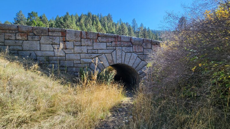 A quarried stone arch bridge built in 1936 in a style reminiscent of the 1800s. The Eastside trail goes underneath the bridge.