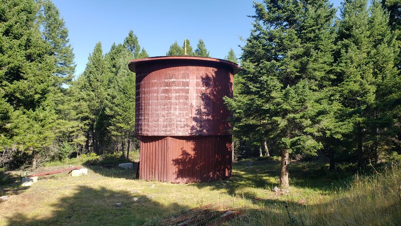 An old historic water tower that has been restored. There are some interpretive signs that tell of the history and restoration process.