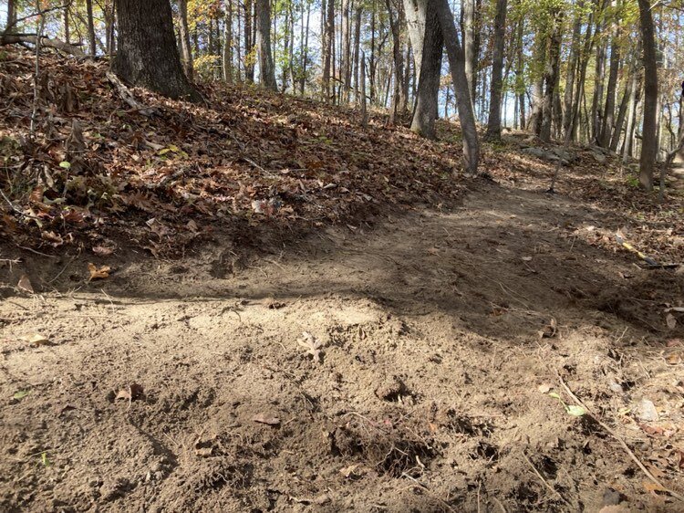 Bench cut reroute downhill of rock roll.