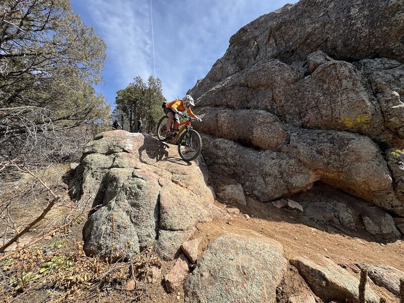 Optional rock roll feature on far out - when riding the trail west to east, there will be a black diamond sign pointing to the left, with a bypass to the right.