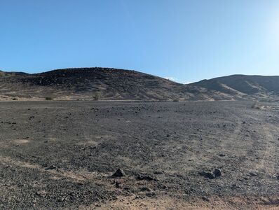 The flat area after 2nd wash crossing;  Look for Rock Art