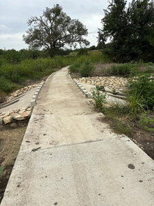 Creek crossing on paved bridge.