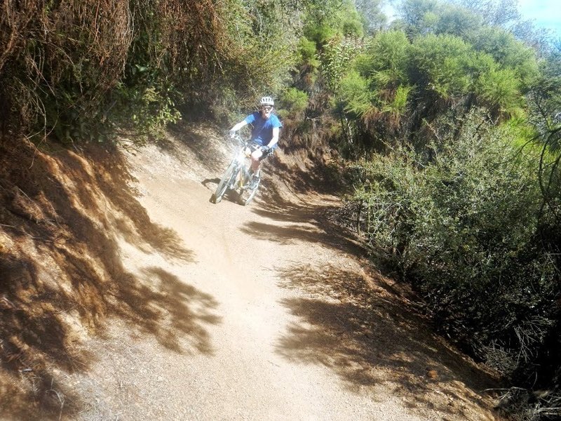 My friend rounding a corner on his first mountain bike ride