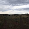 Cairn at fork in the trail indicates time to take a left turn, which will take you back to the parking lot/trailhead