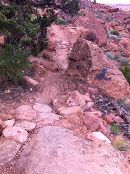 Pump the rock-armored roller, squeeze through the narrow G-out, and carry your momentum up the rock-armored punchy climb. Photos can be deceiving.