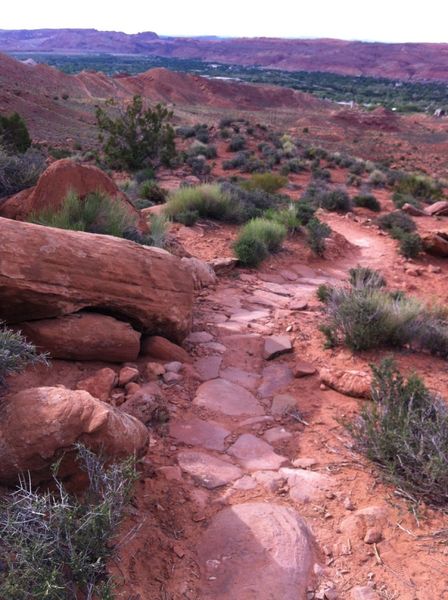 Props to TrailMix for all the rock-armoring. The strip of lush green is Moab valley sitting in the background.