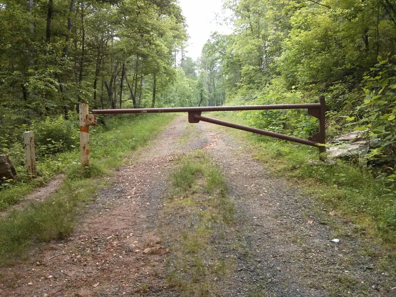 Gate dividing the parking area from the Forest Service road.